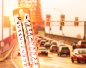 picture is of a road on a summer day with the image of a thermometer